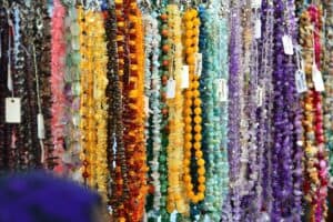 Jewelry making supplies with beads, wire and pliers laid out on a table