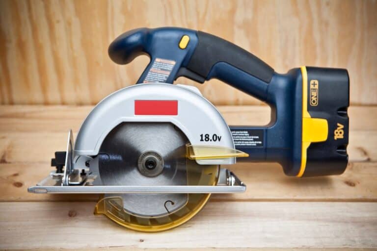 Beginner using a corded circular saw to cut a board