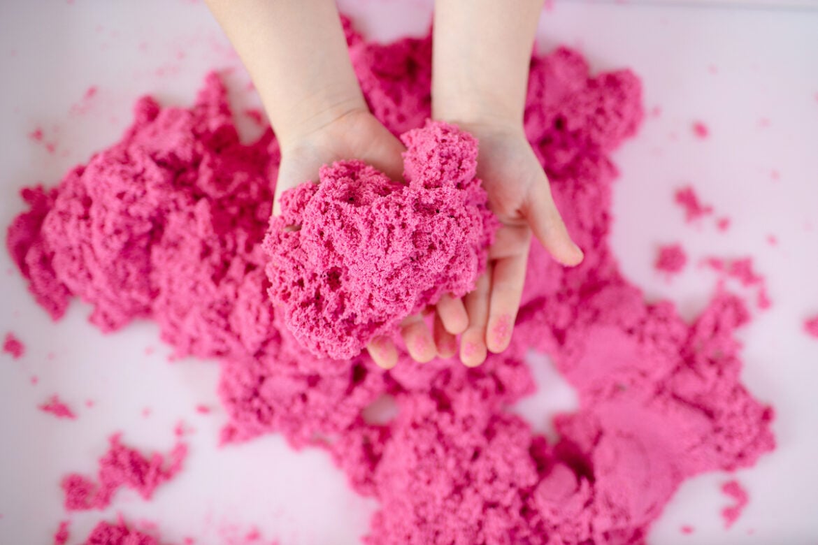 Child's Hands Holding KInetic Sand