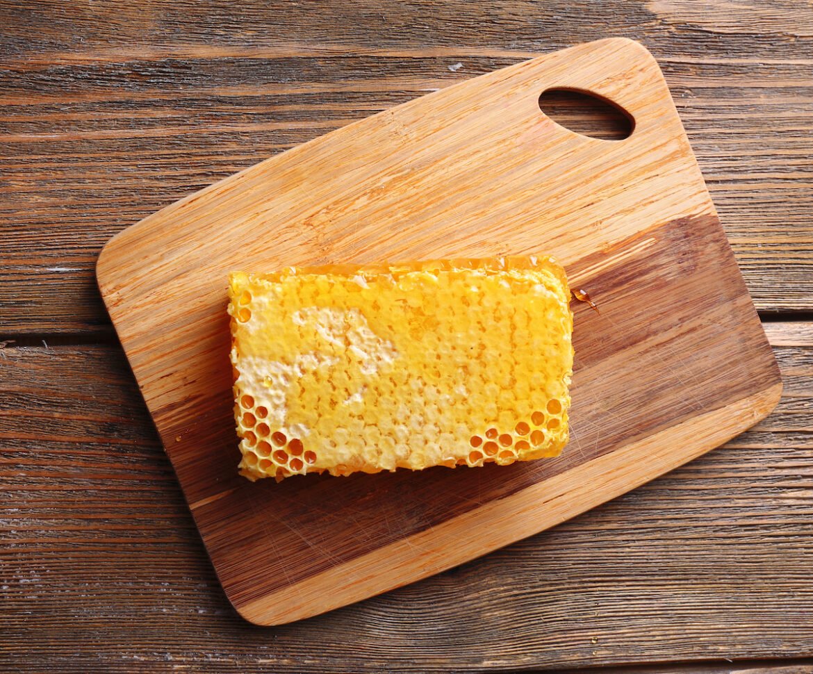 Honeycomb Sitting On Wooden Cutting Board