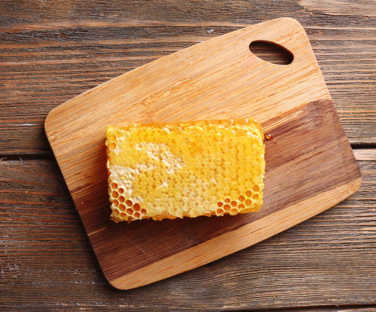 Honeycomb Sitting On Wooden Cutting Board