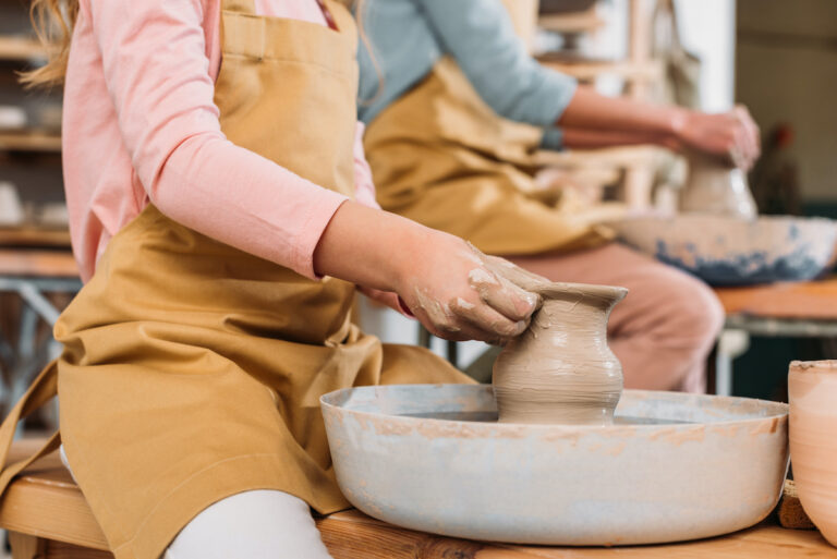Child Making Pottery With Pottery Wheel