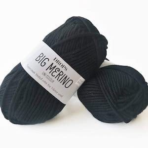 two skeins of black Aran wool yarn