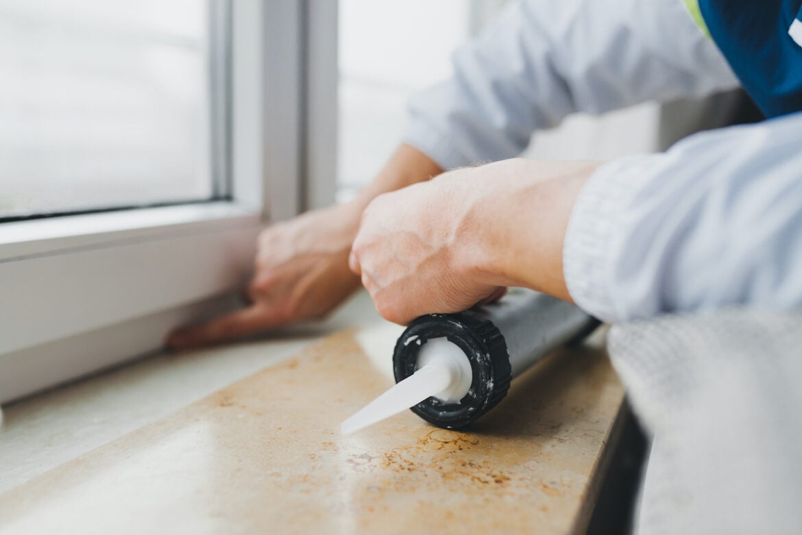 Person With Window Caulk