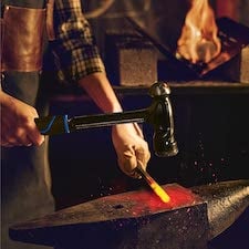 man using ball-peen hammer to forge metal