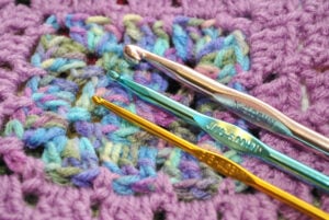 Crochet Accessories - The Creative Folk Three crochet hooks resting on a purple granny square