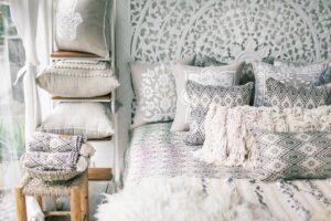 Embroidery Gift Ideas - The Creative Folk Embroidered and patterned cushions stacked on a bed